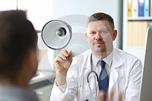 Doctor listening to the patient while he is telling about his problems. Male doctor taking notes. Just hands over the