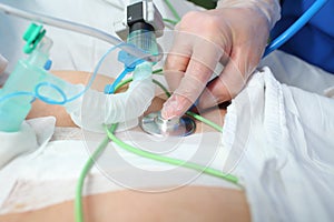 Doctor listens heart with a stethoscope