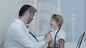 Doctor listens to the lungs stethoscope .