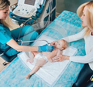 Doctor and little boy patient. Ultrasound equipment.