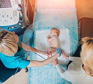 Doctor and little boy patient. Ultrasound equipment. Sonography. Hip dysplasia photo