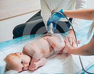 Doctor and little boy patient. Ultrasound equipment. Sonography. Hip dysplasia