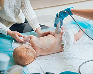 Doctor and little boy patient. Ultrasound equipment. Sonography. Hip dysplasia photo