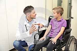 Doctor and little child in wheelchair