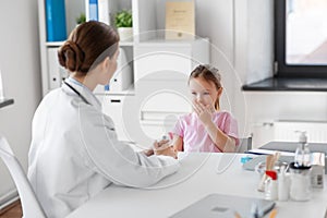 doctor and little girl patient coughing at clinic