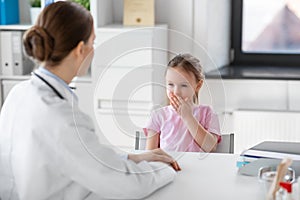 doctor and little girl patient coughing at clinic