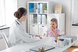 doctor and little girl patient coughing at clinic