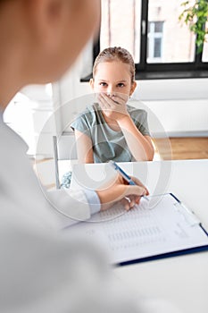 doctor and little girl patient coughing at clinic