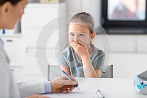 doctor and little girl patient coughing at clinic