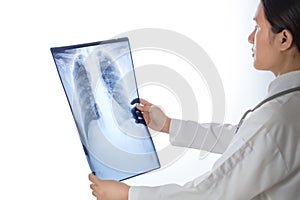 Doctor looking chest x-ray film over white background