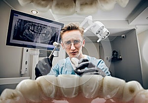 Doctor looking into the mouth, checking, examining teeth
