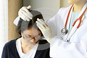 Doctor looking at patient`s hair and scalp, Dermatologist exam scalp disorder.