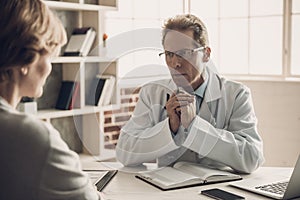 Doctor looking at Patient with Serious Expression