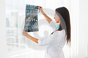 Doctor looking at x-ray or MRI concept healthcare, medical and radiology concept.