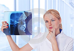 Doctor looking at X-ray results of her patient