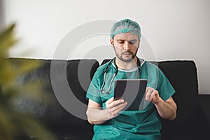 Doctor looking at tablet in the resting room