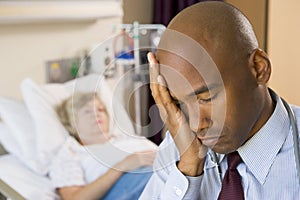 Doctor Looking Tired In Hospital Room photo