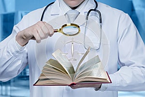 Doctor looks legal textbook through a magnifying glass