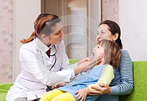 Doctor looks mouth of baby