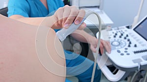Doctor makes ultrasound of shoulder joint man using ultrasound scanner, closeup.