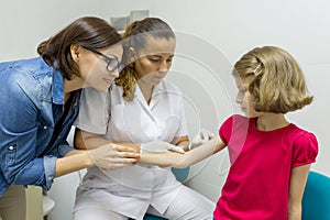 Doctor makes vaccination to a child. Inoculation in the shoulder, in the hospital. Medicine, healthcare, pediatry and people conce