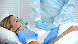 Doctor making cardiopulmonary resuscitation to female patient, reanimation