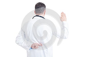 Doctor making false oath with crossed fingers behind back