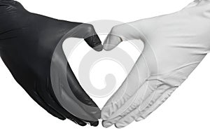 Doctor making heart shape with hands in different medical gloves