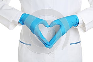Doctor making heart shape with hands in medical gloves