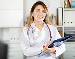 Doctor making notes on clipboard