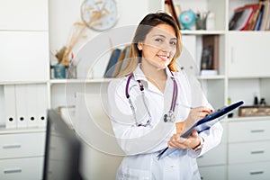 Doctor making notes on clipboard