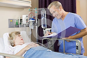 Doctor Making Notes About Senior Woman Patient
