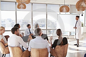 Doctor Making Presentation To Medical Staff In Hospital photo