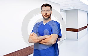 doctor or male nurse in blue uniform