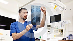 doctor or male nurse looking at x-ray scan