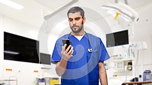 doctor or male nurse using smartphone