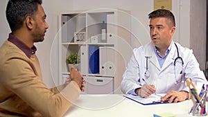 Doctor and male patient talking at hospital