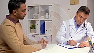 Doctor and male patient talking at hospital