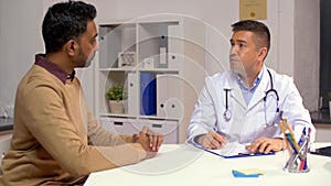 Doctor and male patient talking at hospital