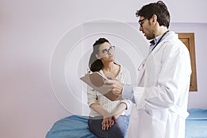 Doctor male talking to patient female at the Doctors consult. Medical concept