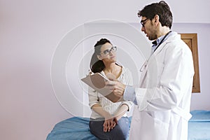 Doctor male talking to patient female at the Doctors consult. Medical concept photo