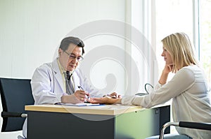 Doctor male using stethoscope to woman patient for listening heart rate on sickbed at hospital,Selective focus hand