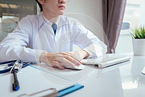 Doctor male working with computer on desk clinic health care for patient technology help support