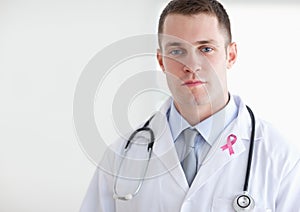 Doctor man with breast cancer awareness ribbon