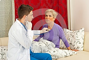 Doctor man examine senior woman home