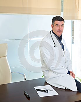 Doctor man expertise portrait casual sitting in hospital office