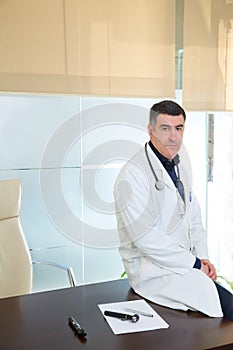 Doctor man expertise portrait casual sitting in hospital office