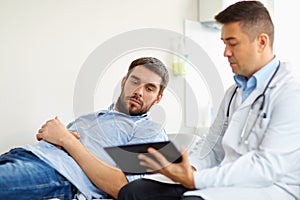 Doctor and man with health problem at hospital
