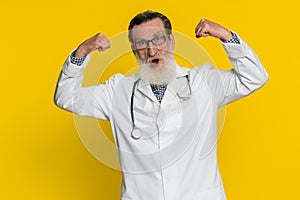Doctor man looking confident showing biceps, feeling power strength to fight for rights, success win