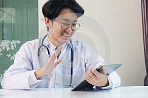 Doctor man smile raise hands to greet patients modern smart digital tablet computer